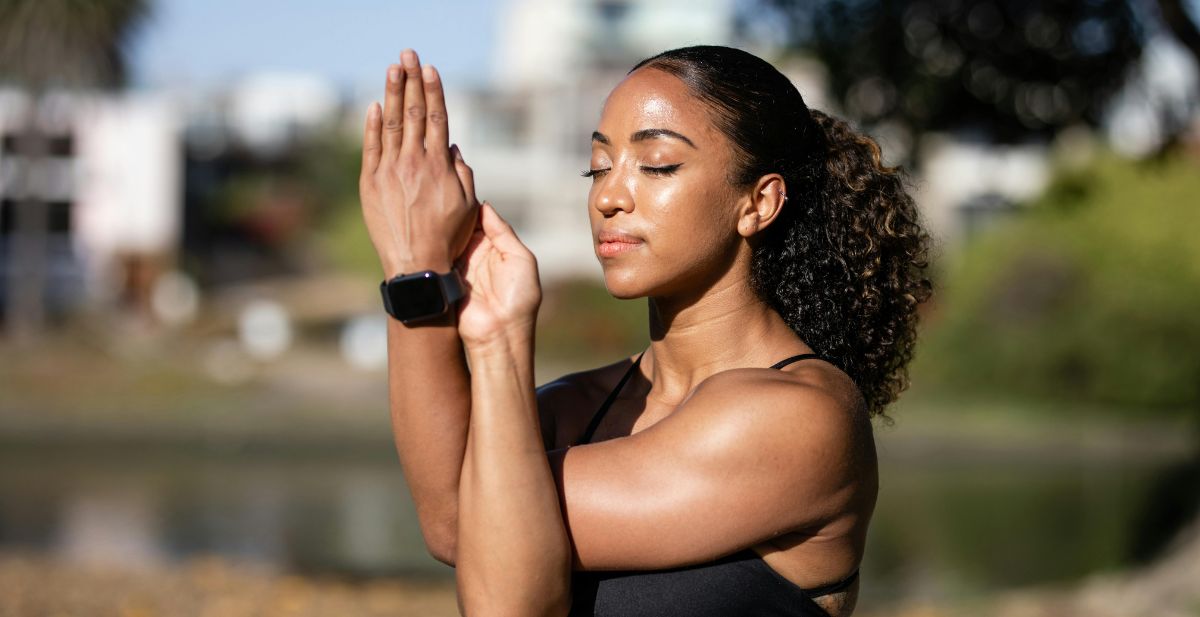Woman outside stretching arms