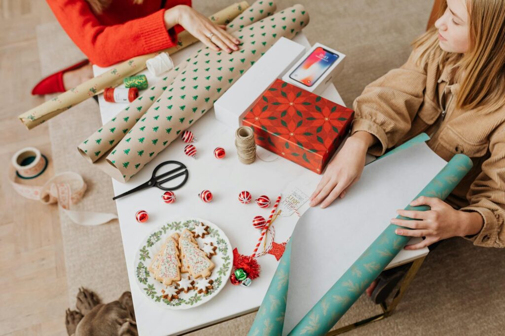 Festive setup showcasing Christmas gift wrapping and decorated cookies, perfect for holiday inspiration.